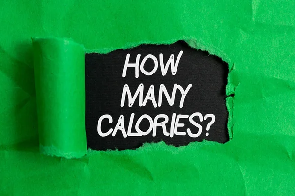 Handwriting text writing How Many Calories Question. Concept meaning asking how much energy our body could get from it Rolled ripped torn cardboard placed above a wooden classic table backdrop. — Stock Photo, Image