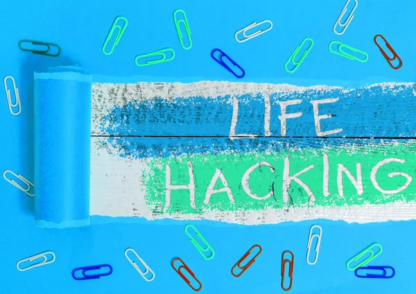 Text sign showing Life Hacking. Conceptual photo Simple and clever techniques in accomplishing task easily Rolled ripped torn cardboard placed above a wooden classic table backdrop.