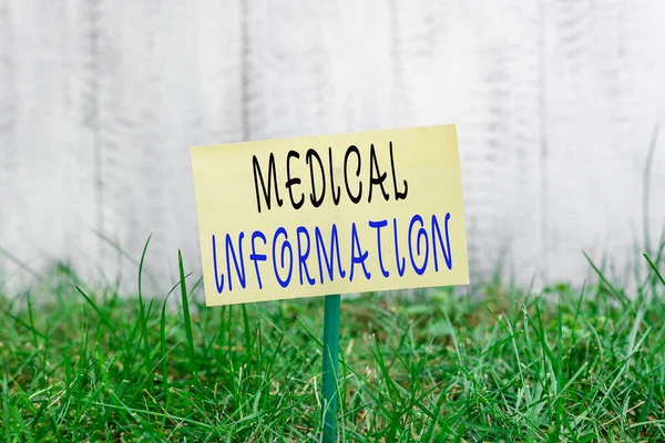 Word writing text Medical Information. Business concept for an individual demographic information and medical histories Plain empty paper attached to a stick and placed in the green grassy land.