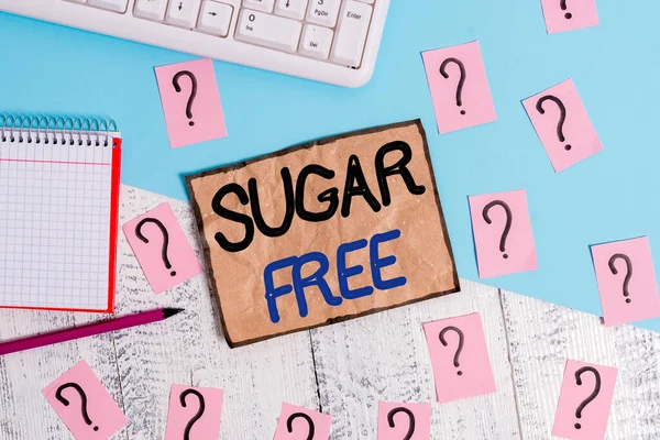 Writing note showing Sugar Free. Business photo showcasing do not contain sugar and only have artificial sweetener instead Writing tools and scribbled paper on top of the wooden table.