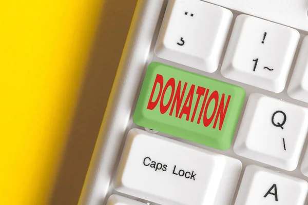 Writing note showing Donation. Business photo showcasing something that is given to a charity, especially a sum of money Colored keyboard key with accessories arranged on empty copy space.