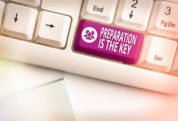 Conceptual hand writing showing Preparation Is The Key. Business photo showcasing it reduces errors and shortens the activities Colored keyboard key with accessories arranged on copy space.