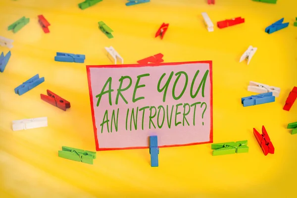 Writing note showing Are You An Introvertquestion. Business photo showcasing an individual who tends to turn inward mentally Colored clothespin papers empty reminder yellow floor background office. — Stock Photo, Image