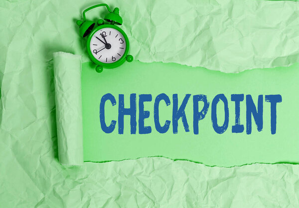 Text sign showing Checkpoint. Conceptual photo manned entrance, where travelers are subject to security checks Rolled ripped torn cardboard placed above a wooden classic table backdrop.