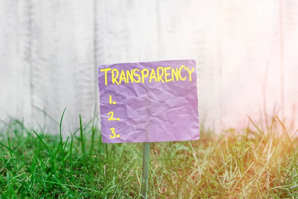 Conceptual hand writing showing Transparency. Business photo text something transparent especially a picture viewed by light Plain paper attached to stick and placed in the grassy land. — Stock Photo, Image