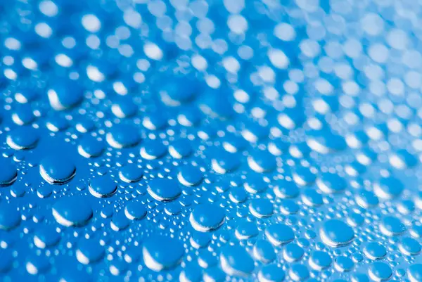Drops Of Rain On Blue Glass Background. Soft focus macro shot with shallow depth of field — Stock Photo, Image