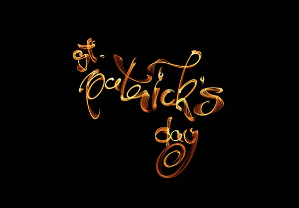Elegant greeting card design with creative shiny lettering calligraphy text Happy St. Patricks Day made of fire flame or smoke isolated on black background — Stock Photo, Image