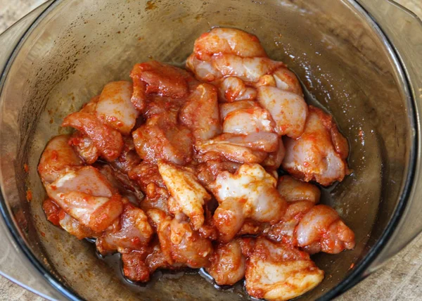 Marinated chicken indian tandoori seasoning in a bowl, on wooden background, in the kitchen — Stock Photo, Image