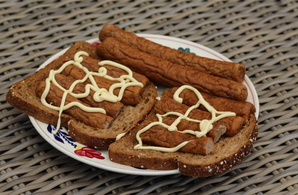 Frikandel on bread with mayonnaise, a traditional Dutch snack, a sort of minced meat hot dog — Stock Photo, Image