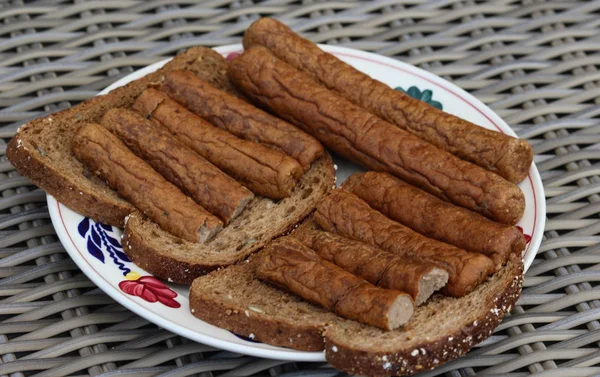Frikandel on a slice of bread, a traditional Dutch snack, a sort of minced meat hot dog — Stock Photo, Image