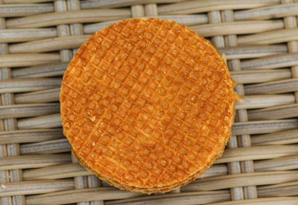 Stack of traditional dutch stroopwafels cookie, a caramel syrup waffle, on wood background — Stok Foto