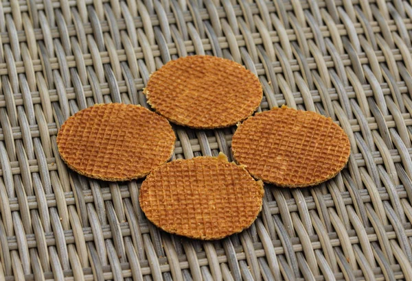 Stack of traditional dutch stroopwafels cookie, a caramel syrup waffle, on wood background — Stok Foto