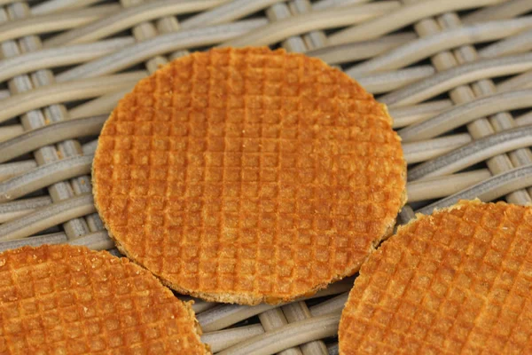 Stack of traditional dutch stroopwafels cookie, a caramel syrup waffle, on wood background — Stok Foto