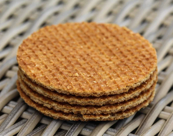 Stack of traditional dutch stroopwafels cookie, a caramel syrup waffle, on wood background — Stok Foto