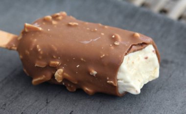 Siyah arka plan üzerinde Vanilyalı sütlü çikolata badem bar dondurma