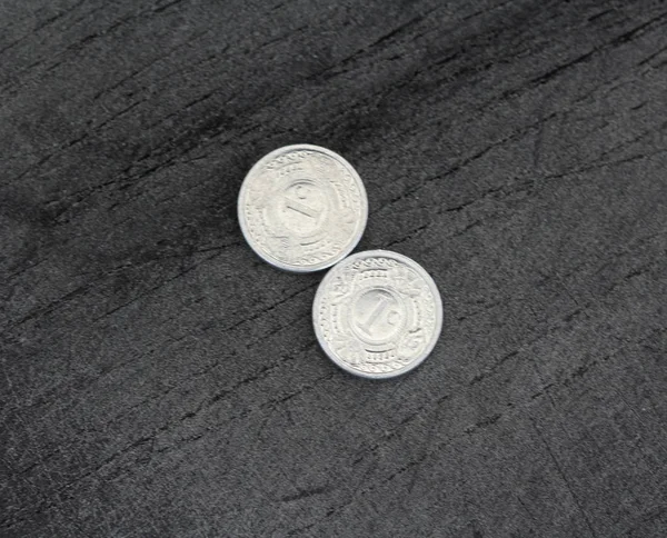 10 (ten) cent Netherlands Antillean guilder coin on black background