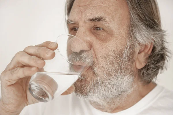 Portrait elderly man drinking water