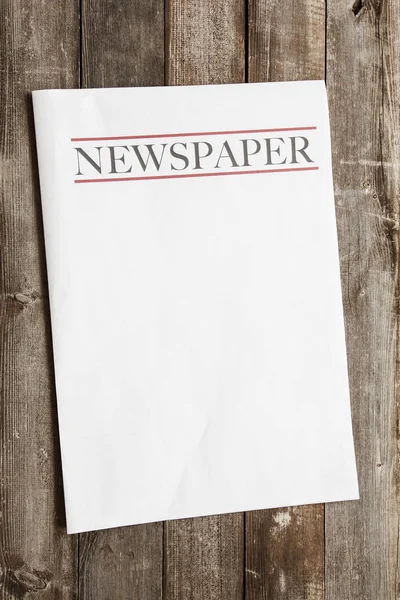 stock image Newspaper on wooden background
