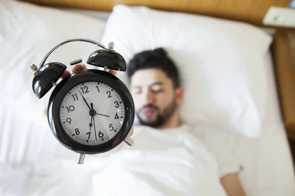 Young man finding it difficult to wake up in the morning