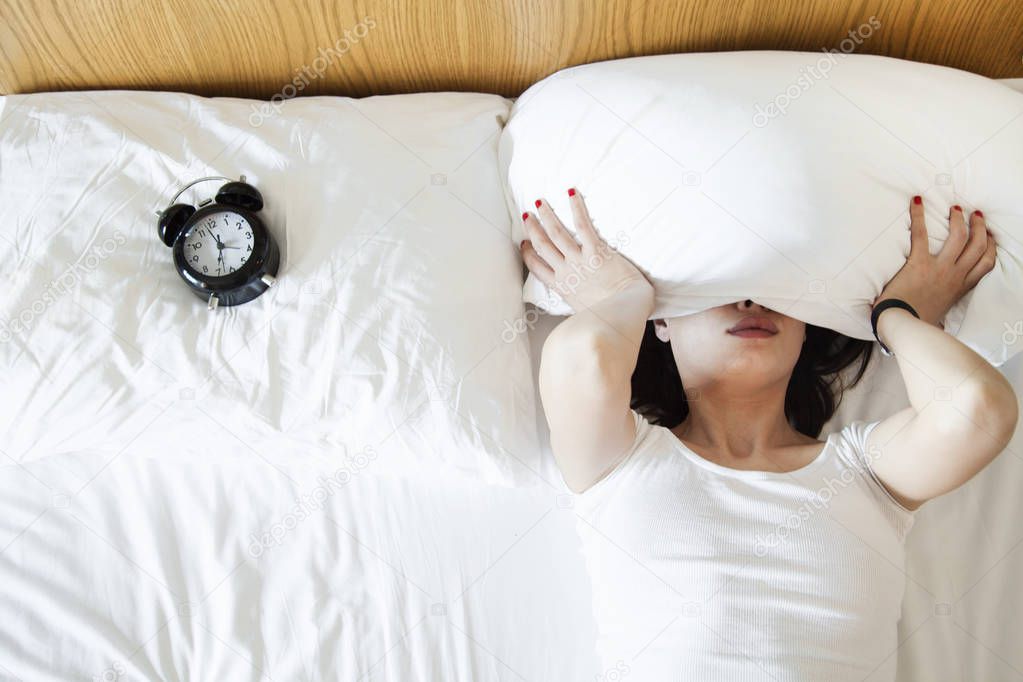 Young woman finding it difficult to wake up in the morning