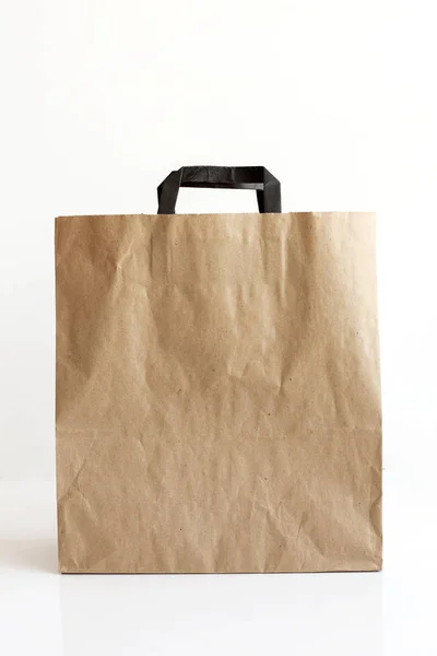 Blank paper carrier bags with handles for shopping.