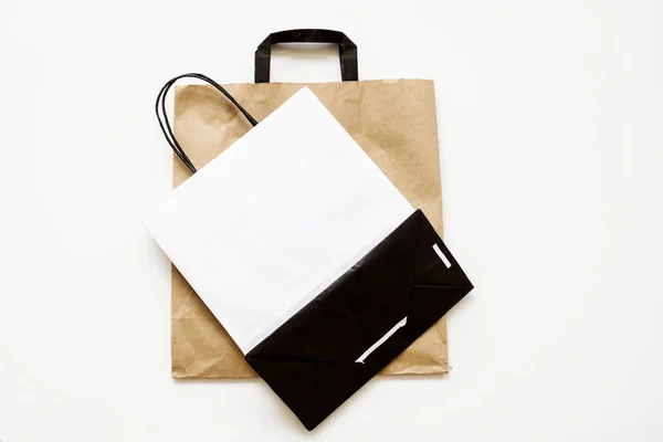 Blank paper carrier bags with handles for shopping.