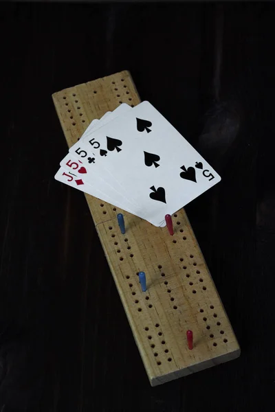 cribbage: playing cards on black background