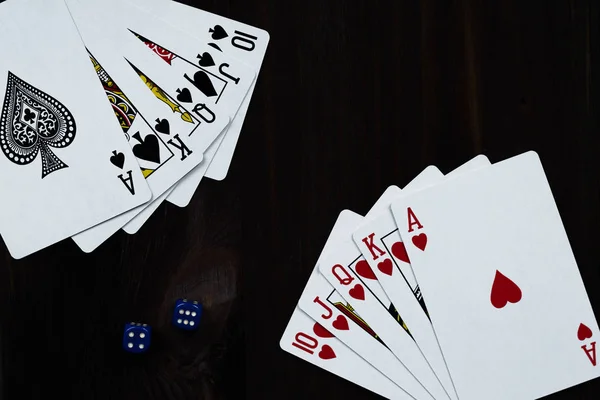 playing cards on black background with dice