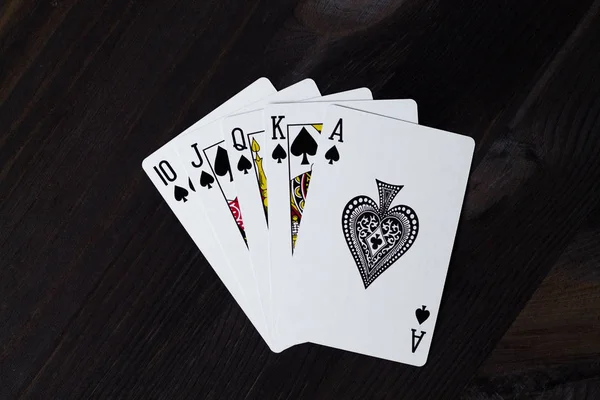 royal flush. playing cards on black background.