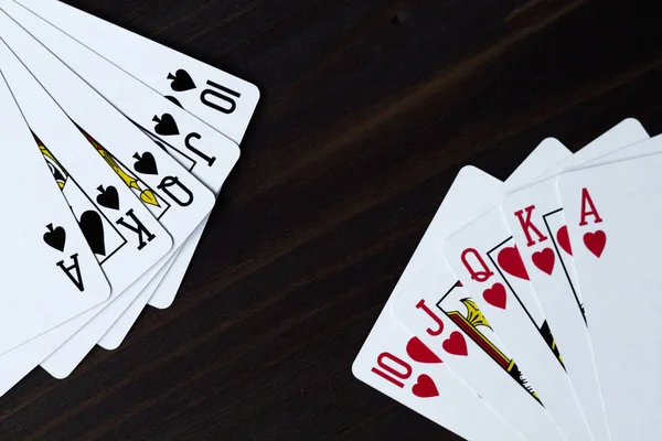 playing cards on black background. royal flush