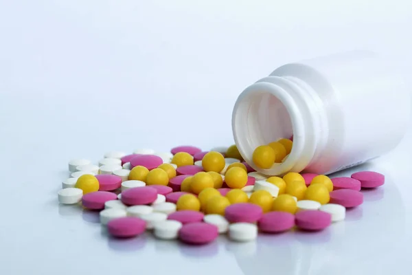 pills and bottle on white background. pills spilling out of pill bottle isolated on white background