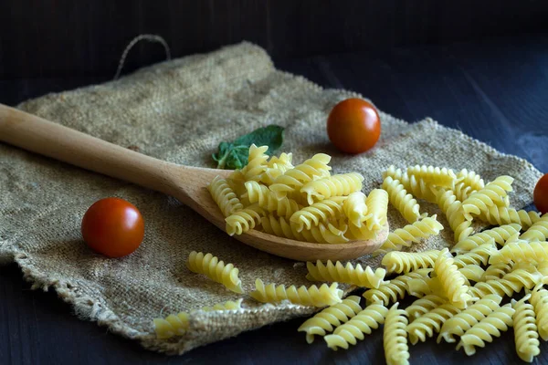 Italian Pasta Tomatoes Fusilli Pasta Sackcloth Wooden Background Raw Pasta — Stock Photo, Image