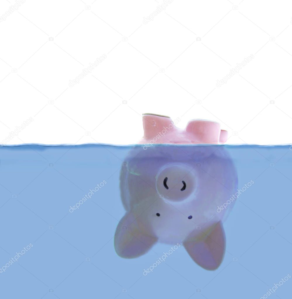 Piggy bank floating upside down under water, with white for copy space