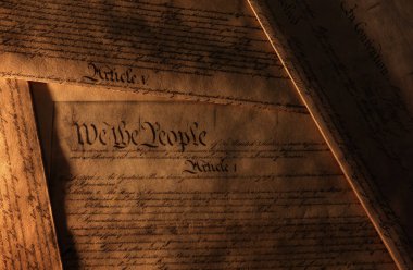 Pages of the United States Constitution showing We The People heading                                clipart