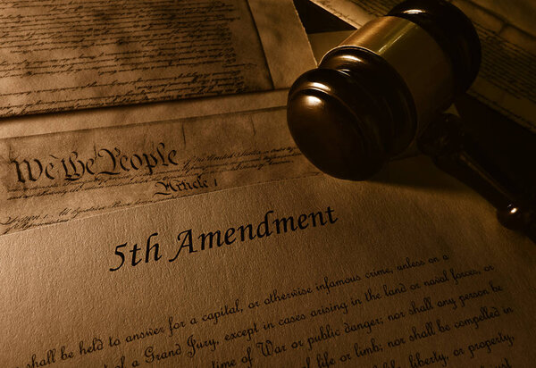 Text of the Fifth Amendment to the US Constitution and gavel