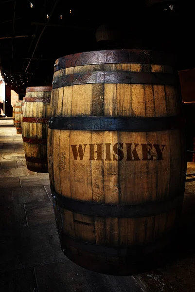 Whiskey barrels in a distillery warehouse