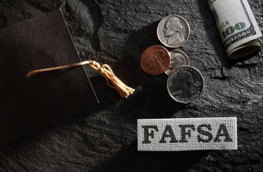 FAFSA (Free Application for Federal Student Aid) text with graduation cap and money -- financial aid concept                                clipart