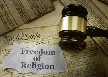  Freedom of Religion newspaper headline on a copy of the US Constitution with gavel                               clipart