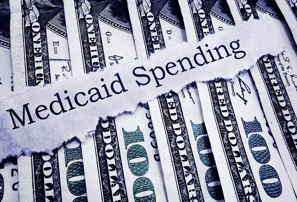 Medicaid Spending newspaper headline on hundred dollar bills