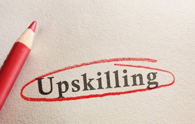 Upskilling text on paper circled in red pencil - job training concept                           clipart