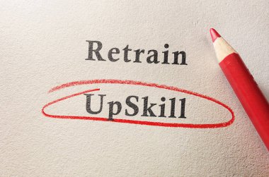 Upskill circled in red pencil below Retrain text on textured paper  --  job training concept                             clipart