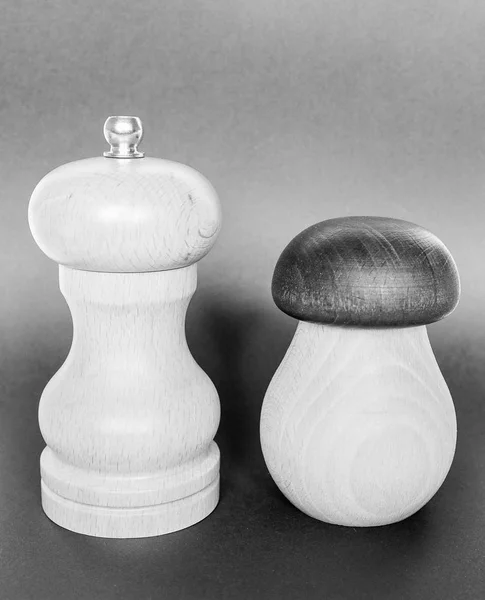 salt and pepper wooden grinders in black and white