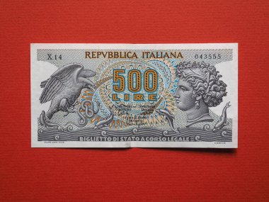 Vintage withdrawn Italian 500 Lire banknote over red background clipart