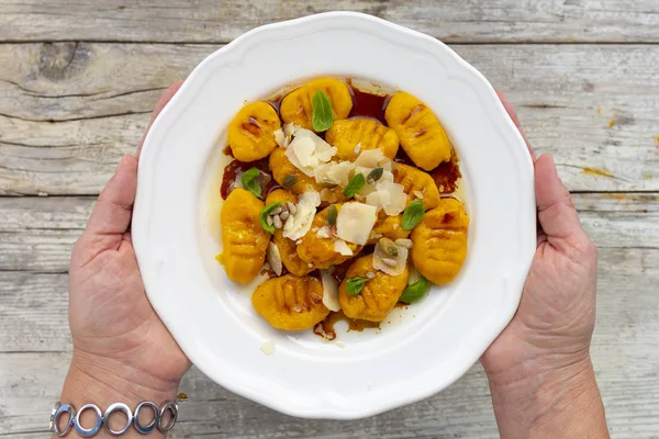 Pumpkin gnocchi with brown buttery sauce and parmesan cheese.