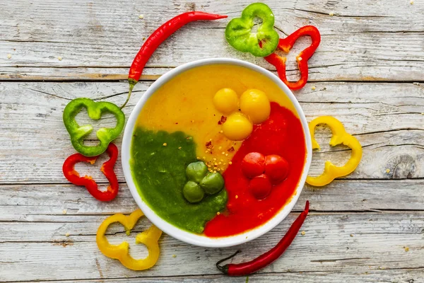 Colorful cream and spicy pepper soup.