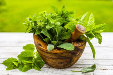 Tahta bir havanda taze ve aromatik bitkiler..