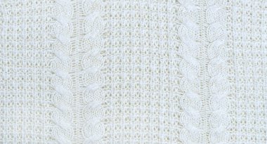 Sorunsuz bej Triko Kumaş dokulu ve Pigtails. Yinelenen doku kazak örgü makinesi. Arka plan bej örme.