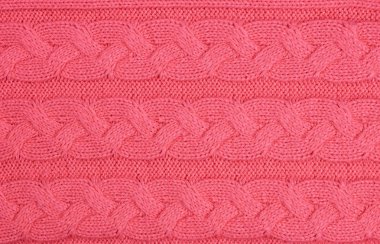 Sorunsuz bej Triko Kumaş dokulu ve Pigtails. Yinelenen doku kazak örgü makinesi. Arka plan bej örme.