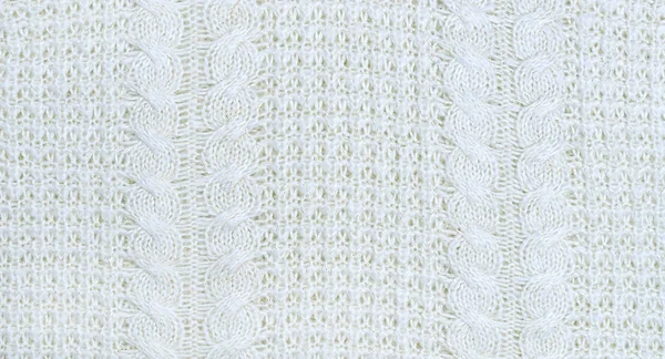 Sorunsuz bej Triko Kumaş dokulu ve Pigtails. Yinelenen doku kazak örgü makinesi. Arka plan bej örme.