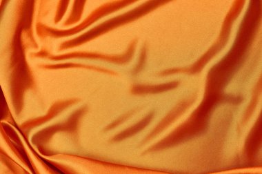 parlak turuncu ipek kumaş ışık arka plan dokusu üzerinde taşan